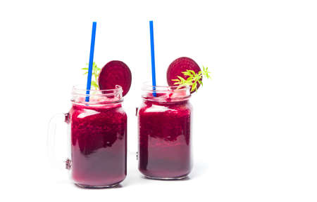 Healthy beet smoothie in a jar isolated on whiteの写真素材