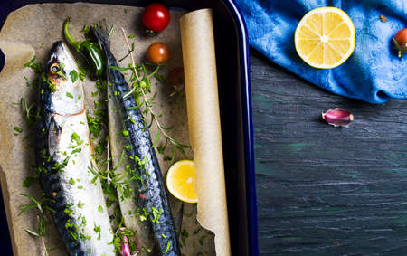 Mackerel fish with cooking ingredients on baking paperの写真素材