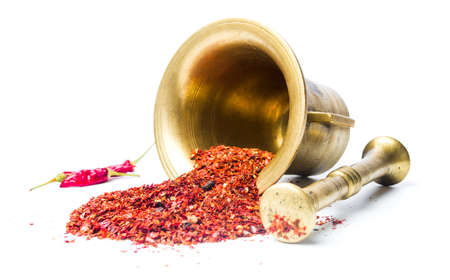 Ground red pepper and a vintage mortar isolatedの写真素材