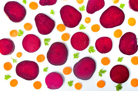 Raw beet and carrot slices isolated on white background の写真素材