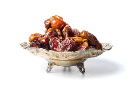 Arabian dates on a plate isolated on white background