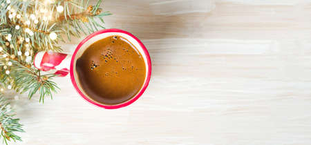 Cup of coffee with festive decorations on the tableの写真素材