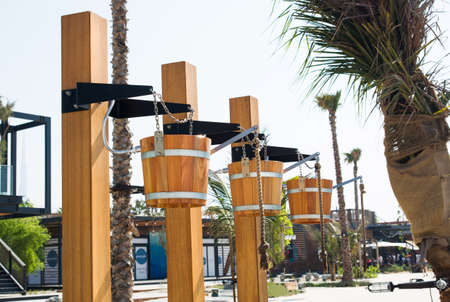 Creative showers in wooden buckets on a beachの写真素材