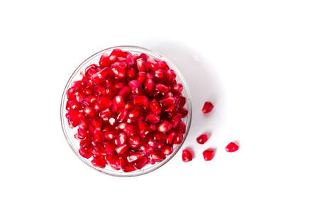 Pomegranate fruits in a glass bowl on white backgroundの写真素材