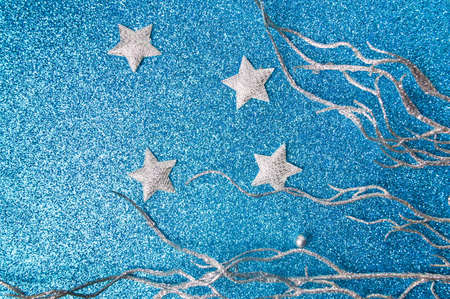 Silver Christmas decorations on shiny blue backgroundの写真素材