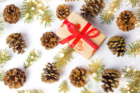 Christmas present with pine cones festive background flat layの写真素材