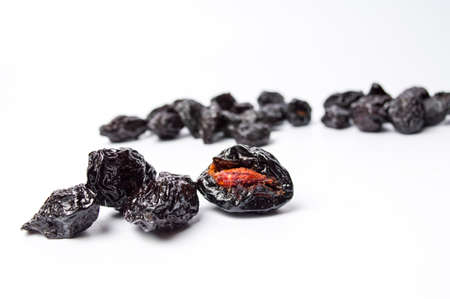Dried plum fruits on white background isolatedの写真素材