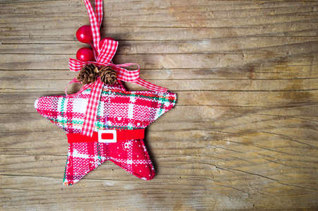 Christmas toy red star with mistletoe on wooden tableの写真素材