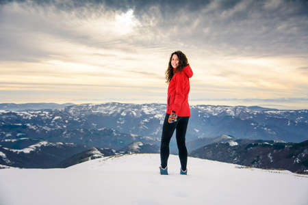 Female hiker on snow covered mountain top. Winter active lifestyleの写真素材