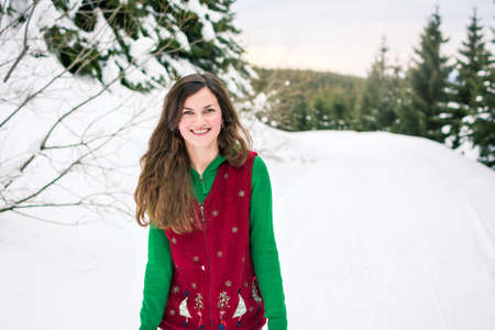 Happy Hipster girl walking on the snowy mountain