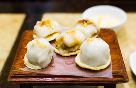 Sticky rice stuffed with mung bean severed on the wooden plate in restaurantの写真素材