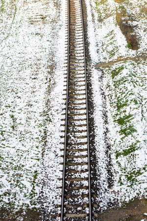 Railroad track covered with snow top viewの写真素材