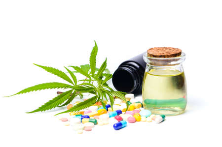 Marijuana oil, leafs with medical pills isolated on whiteの写真素材
