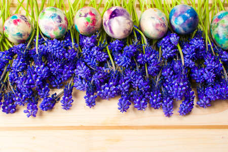 Hand painted Easter eggs and purple spring flowersの写真素材