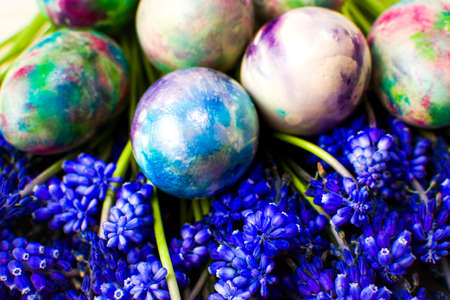Hand painted Easter eggs and purple spring flowersの写真素材