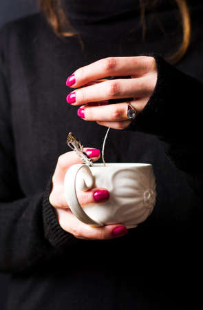 Female hands taking out teabag close upの写真素材
