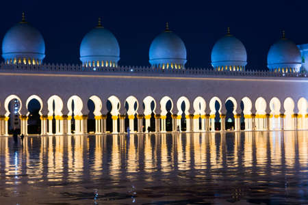 Sheikh Zayed Mosque pillars reflected in the marble floor at night
