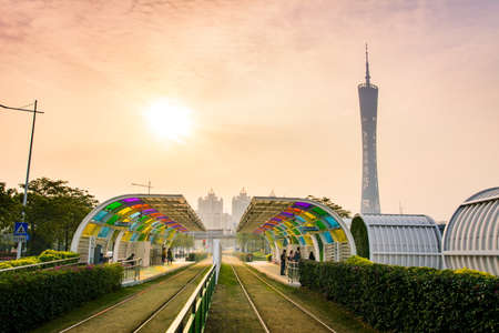 GUANGZHOU, CHINA - JANUARY 3, 2018: Guangzhou city tram station with grass covered rail track  and Canton tower in the backgroundのeditorial素材