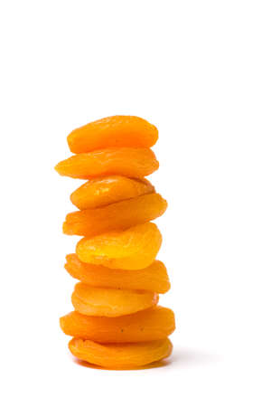 Dried apricot slices on a pile  isolated on white backgroundの写真素材