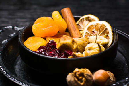 Dried fruit slices on a dark plate top viewの写真素材