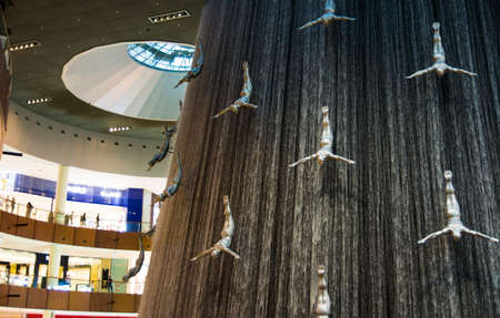 DUBAI, UNITED ARAB EMIRATES - FEBRUARY 5, 2018: Water wall in Dubai mall known as Human Waterfalls where the cascading water occupies the height of the mall. The Dubai Mall is the largest mall in the world by total areaのeditorial素材