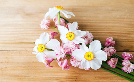 Colorful spring flowers mixed bouquet on a wooden tableの写真素材