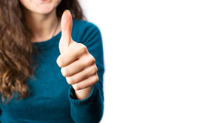  Female showing a thumbs up gesture close upの写真素材