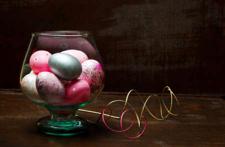 Painted Easter eggs in a glass vaseの写真素材