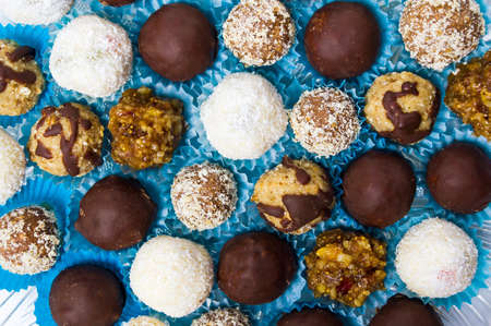 Homemade cookies in paper cups on blue background top viewの写真素材