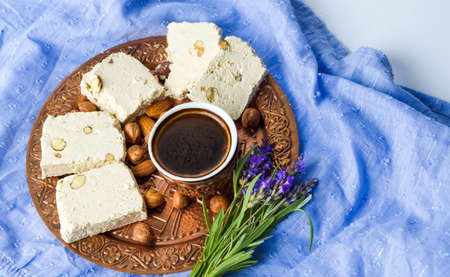 Halva dessert and black coffee on a trayの写真素材