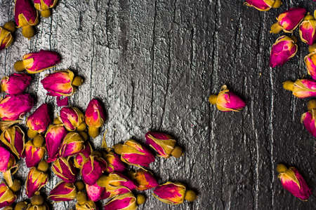 Rose tea buds on dark wooden backgroundの写真素材
