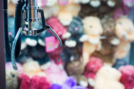 Claw crane arcade with toy rewards in the backgroundの写真素材