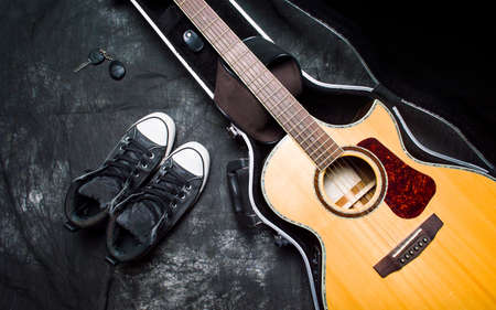 Acoustic guitar in a case on dark background topの写真素材