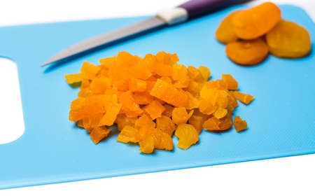 Sliced dried apricot fruit on a cutting boardの写真素材