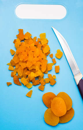 Sliced dried apricot fruit on a cutting boardの写真素材
