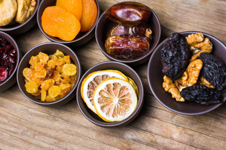 Various dried fruits in small bowls top viewの写真素材