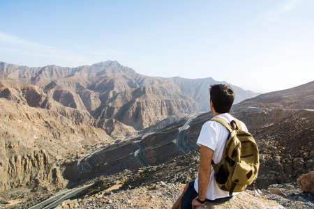 Male hiker enjoying the mountain range viewの写真素材