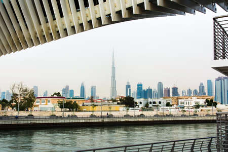 Dubai Water canal footbridge with city panorama in the backgroundの写真素材