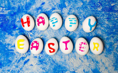 Happy Easter note written on white eggs flat lay