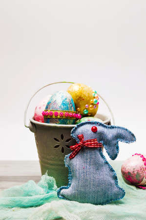 Easter eggs in a can with denim toy bunny