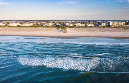 Aerial view of a city from the seaside splashing wavesの写真素材