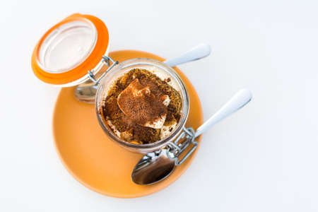 Tiramisu dessert in a jar on a plate top viewの写真素材