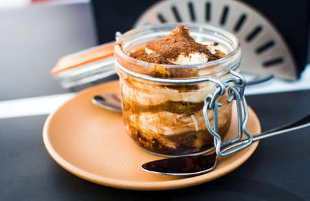 Tiramisu dessert in a jar served on a plateの写真素材