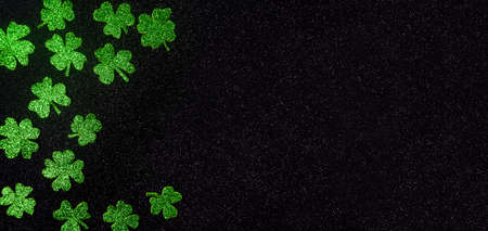 Glittering green clovers background pattern flat lay