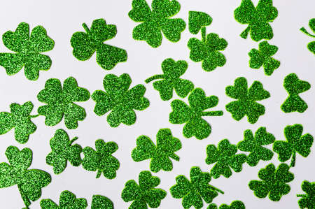 Glittering green clovers background pattern flat layの写真素材