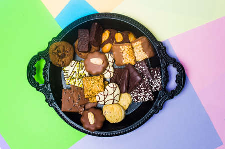 Various chocolate cookies on a plate top viewの写真素材