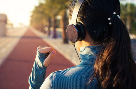 Girl jogging on the running track by the seasideの写真素材