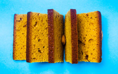 Almond bread slices on blue background top viewの写真素材