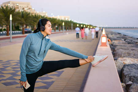 Girl preparing for an outdoor workout by the sea
