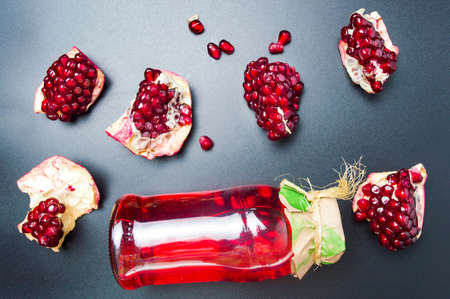Pomegranate juice in a jar with fruit slices top viewの写真素材